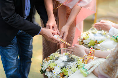 Parents pouring water on bride hands