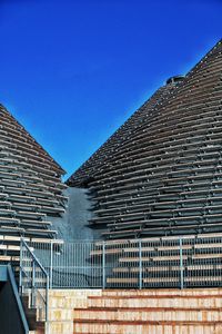 Low angle view of buildings against clear blue sky