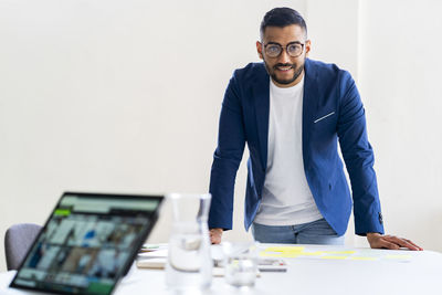 Portrait of man working on table