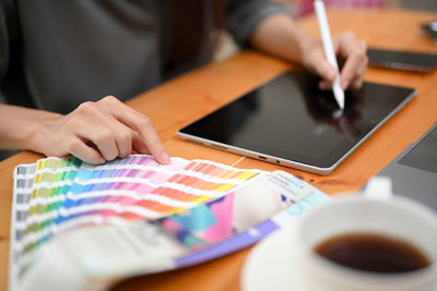 Midsection of man using laptop on table