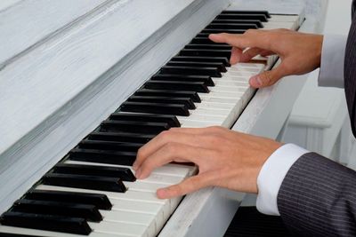 Close-up of man playing piano