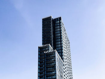 Low angle view of modern building against clear blue sky