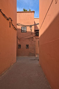 Red colored houses in marrakesh and an alley