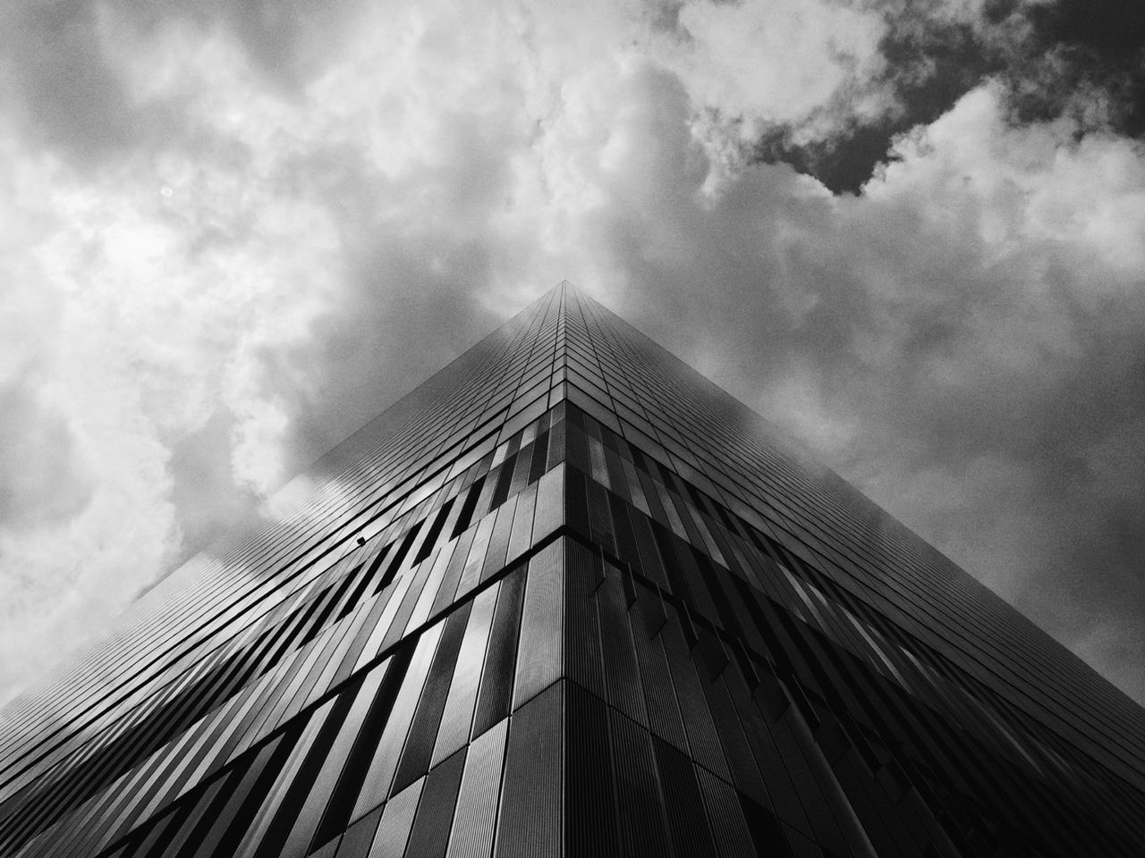 architecture, built structure, building exterior, low angle view, sky, cloud - sky, cloudy, cloud, modern, building, tall - high, city, weather, day, overcast, outdoors, office building, tower, no people, window