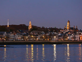 Illuminated city at waterfront