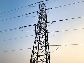 Low angle view of electricity pylon against sky