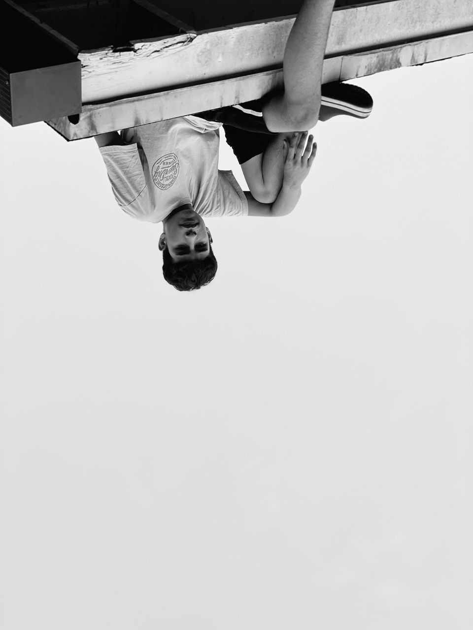 LOW ANGLE VIEW OF MAN IN MID-AIR AGAINST SKY