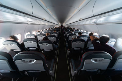 Rear view of people sitting in airplane