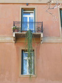 Low angle view of rope hanging on balcony