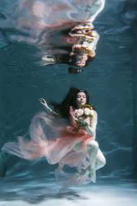 High angle view of woman swimming in sea