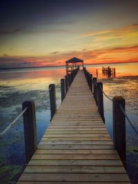Wooden pier leading to calm sea