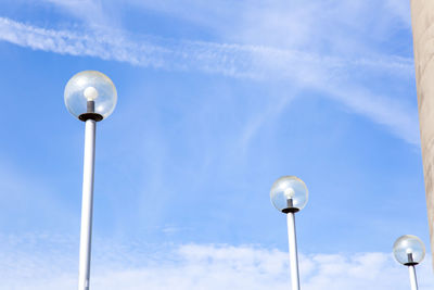 Low angle view of street lights against sky