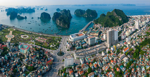 High angle view of cityscape by sea against sky