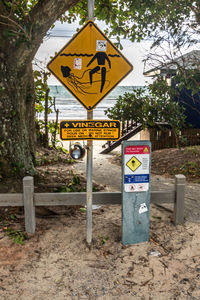 Road sign against trees