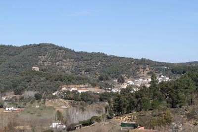 Scenic view of town against clear sky