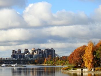 City by river against sky