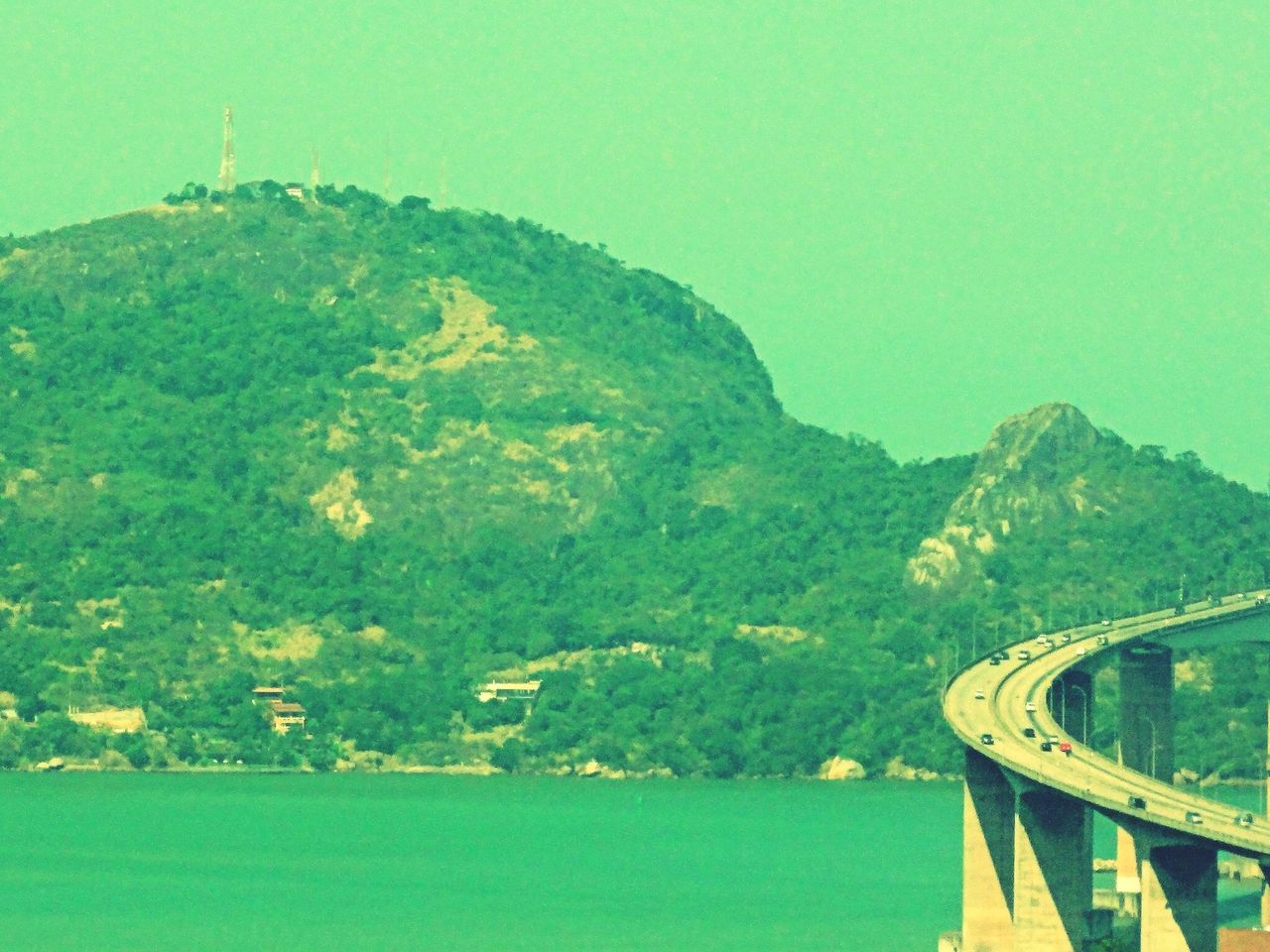 mountain, water, clear sky, connection, tranquility, transportation, tranquil scene, scenics, beauty in nature, nature, built structure, bridge - man made structure, blue, copy space, green color, river, landscape, day, mountain range, architecture