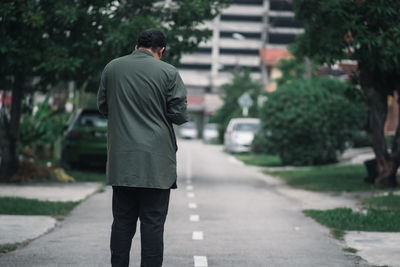 Rear view of man walking on street