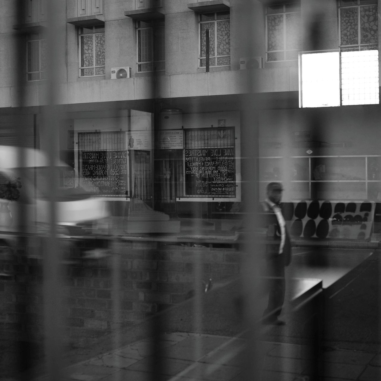 BLURRED MOTION OF BUILDINGS SEEN THROUGH GLASS WINDOW