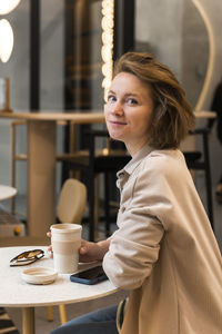 Portrait of young woman using mobile phone