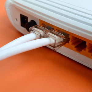 Close-up of computer network cables in router on table
