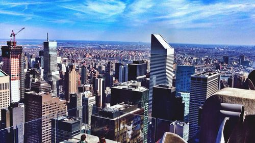 Cityscape against cloudy sky