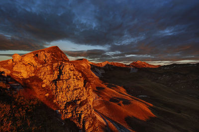 Scenic view of mountains against cloudy sky