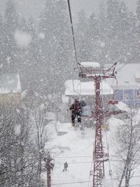 Person on ski lift during snowfall