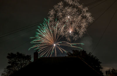 Low angle view of firework display at night