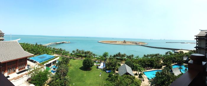 High angle view of swimming pool by sea against clear sky