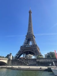 Tower of bridge and buildings against sky