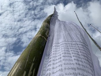 Low angle view of building against cloudy sky