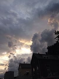 Low angle view of building against cloudy sky