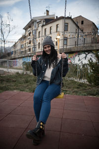 Young woman sitting on swing