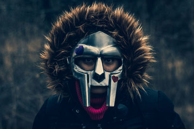 Portrait of mysterious hooded individual wearing a mask.