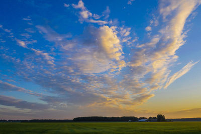 Scenic view of field against sky during sunset