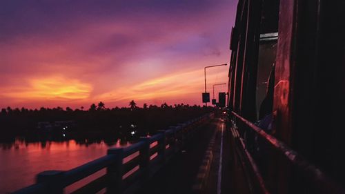 Panoramic view of railroad tracks against sky at sunset