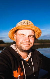 Portrait of man wearing hat against sky