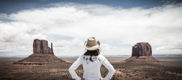 Rear view of man standing on rock