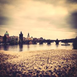 Scenic view of river against cloudy sky