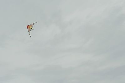 Airplane flying over cloudy sky