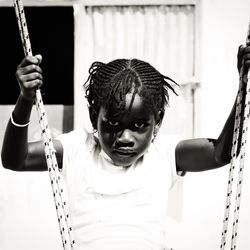 Portrait of girls on swing at park