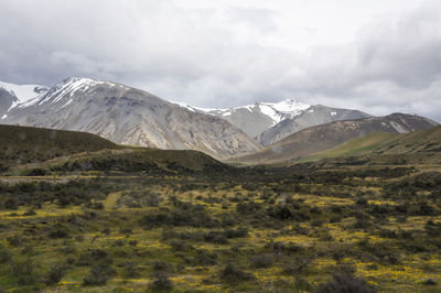 Scenic view of mountains against cloudy sky