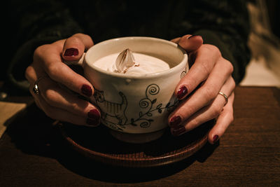 Midsection of coffee cup on table