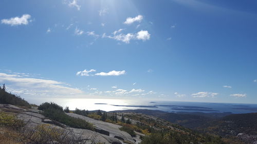 Scenic view of sea and mountains against sky