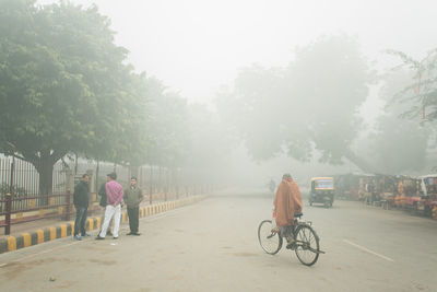 People on city street during foggy weather