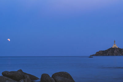 Scenic view of sea against clear blue sky