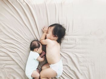 High angle view of mother and baby on bed