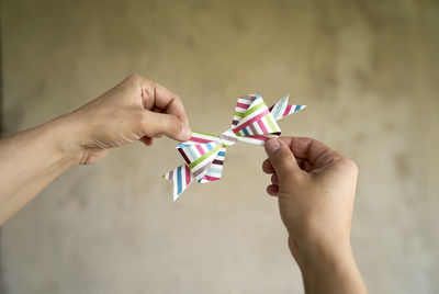 Midsection of person holding paper