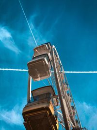 Low angle view of water tower against blue sky